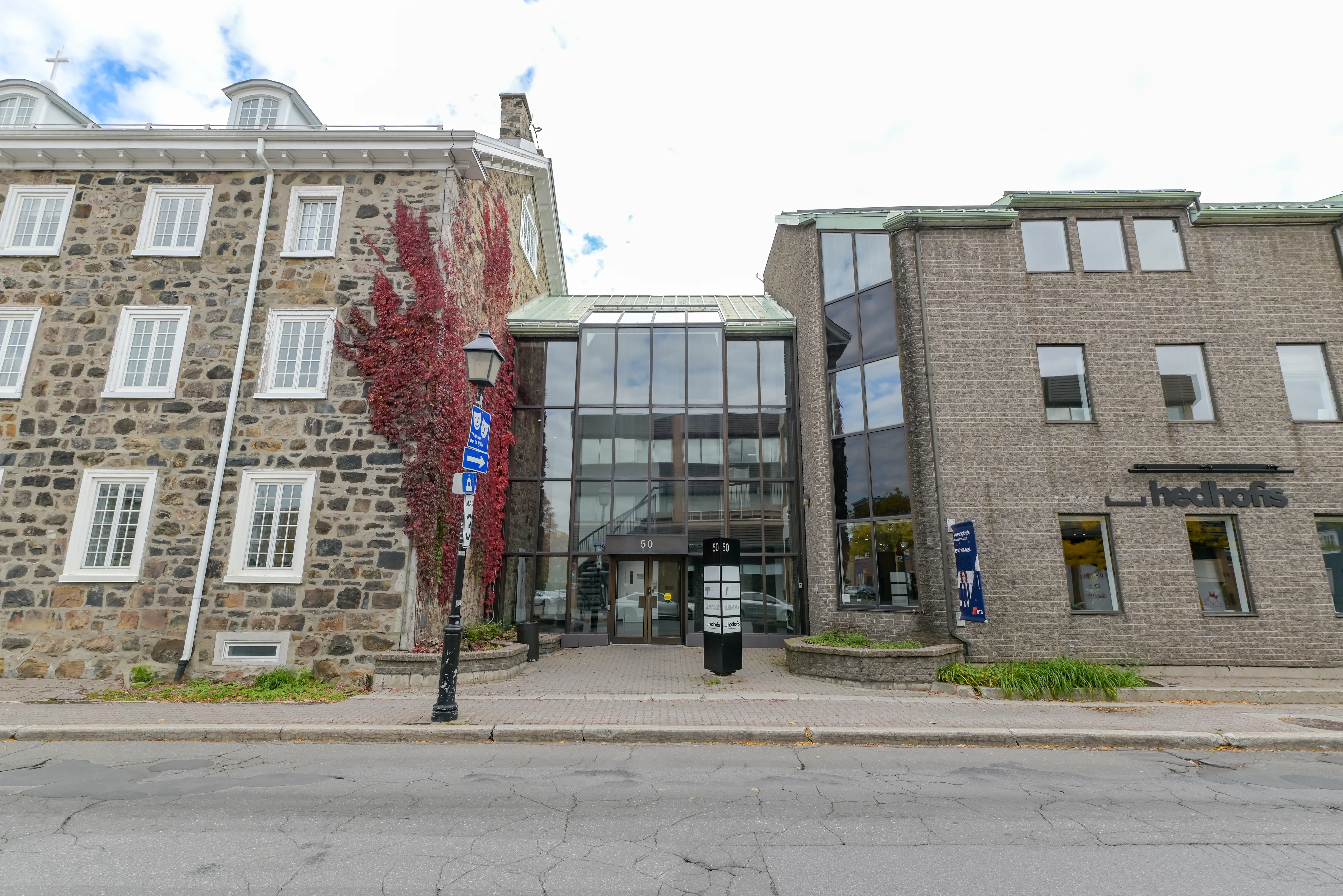 Stone heritage building and glazed entrance on Saint-Charles Ouest