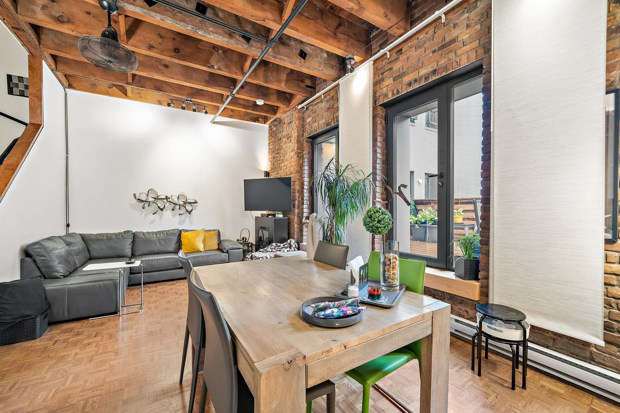 Loft bedroom with arched windows and timber beams