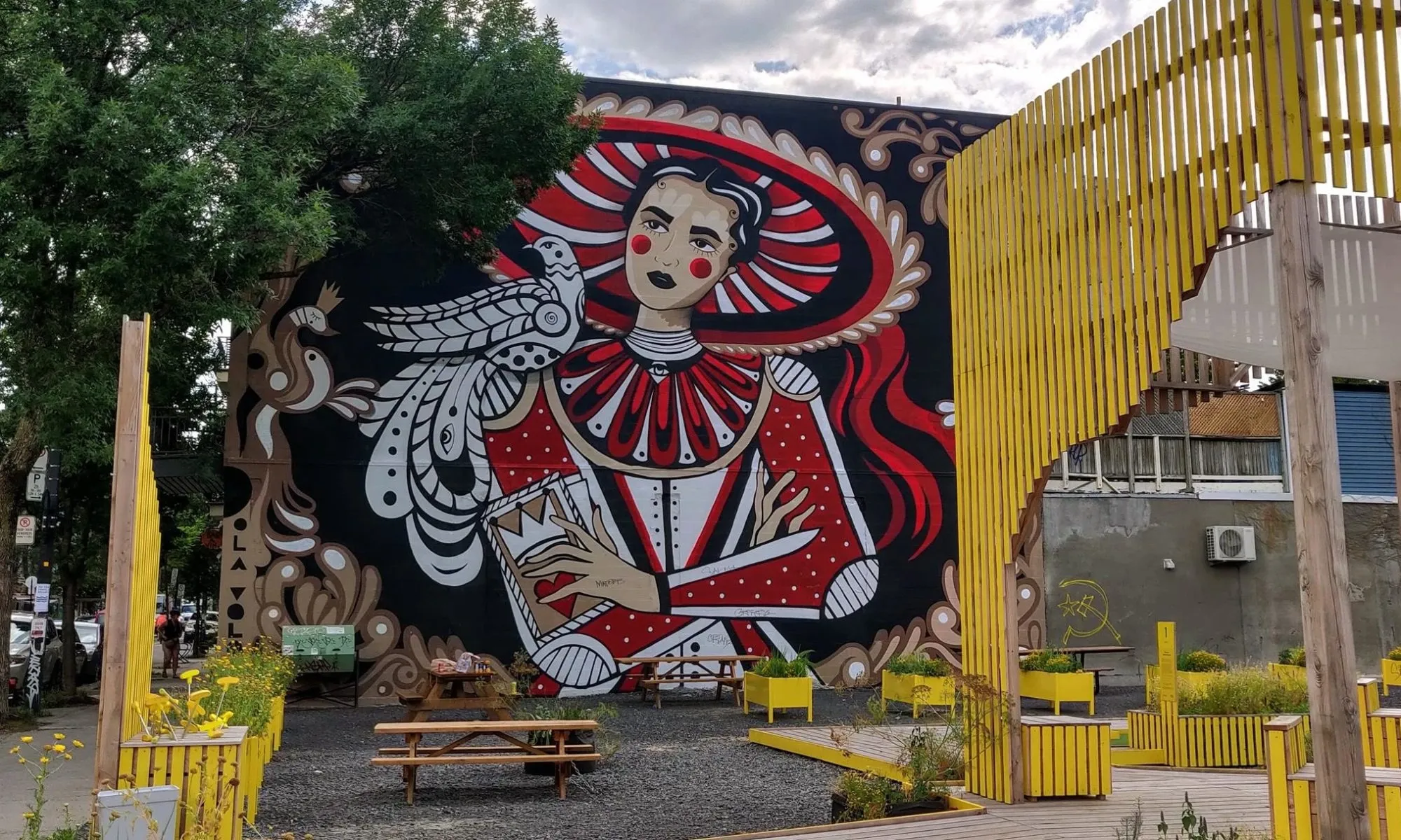 A mural beside 1675 Laurier Est, facing the public terrasse and planters on the street
