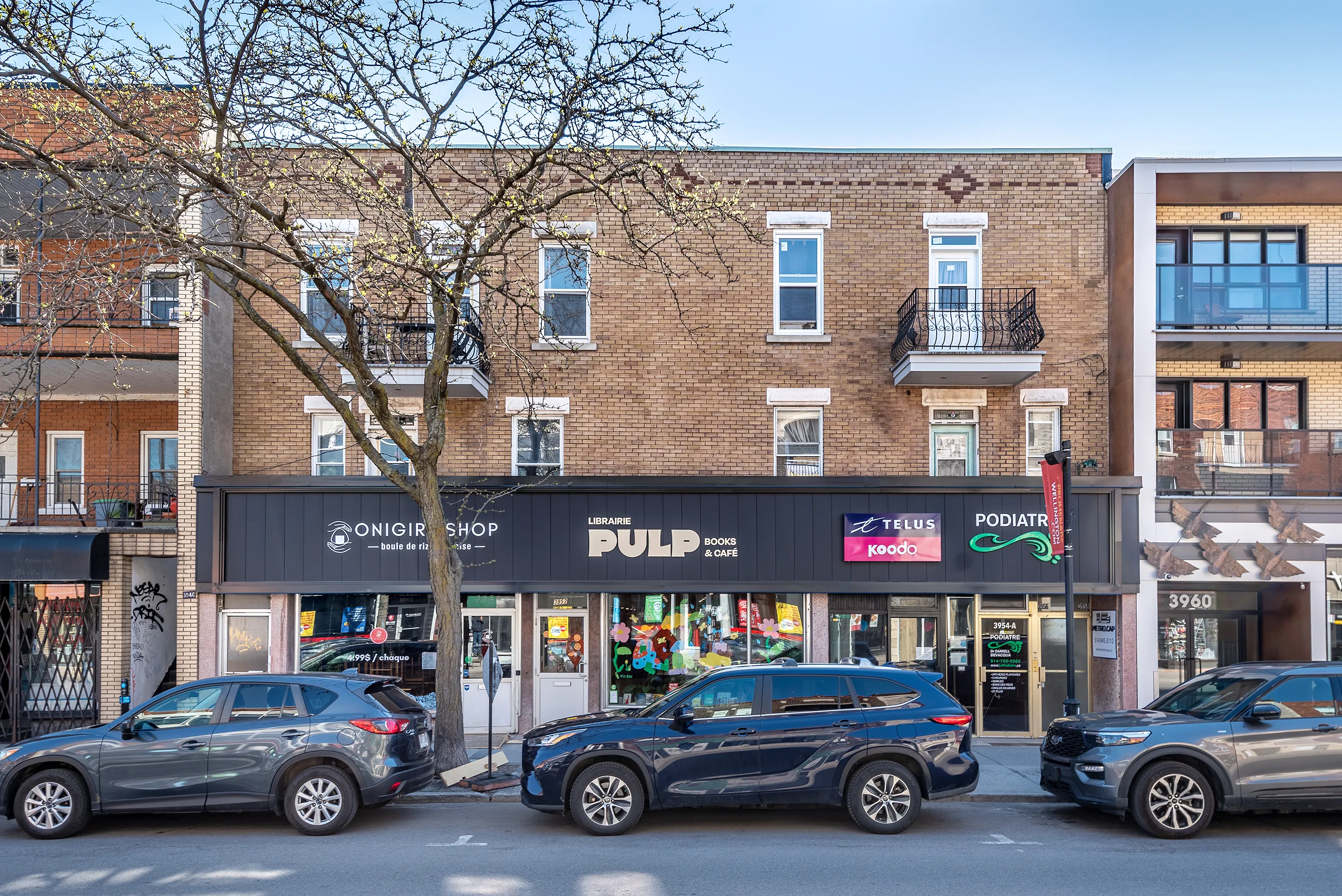 3946-3954 Wellington: Librairie Pulp Books, Telus and a podiatry clinic at grade, apartments above